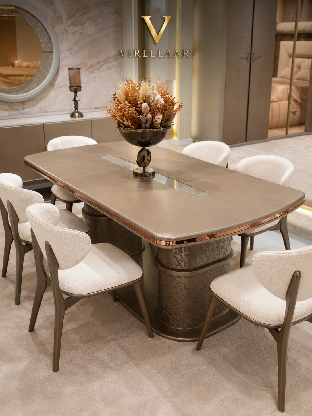 Aspendos dining table and six ivory chairs viewed from above with bronze-tone trim and twin sculptural pedestal bases