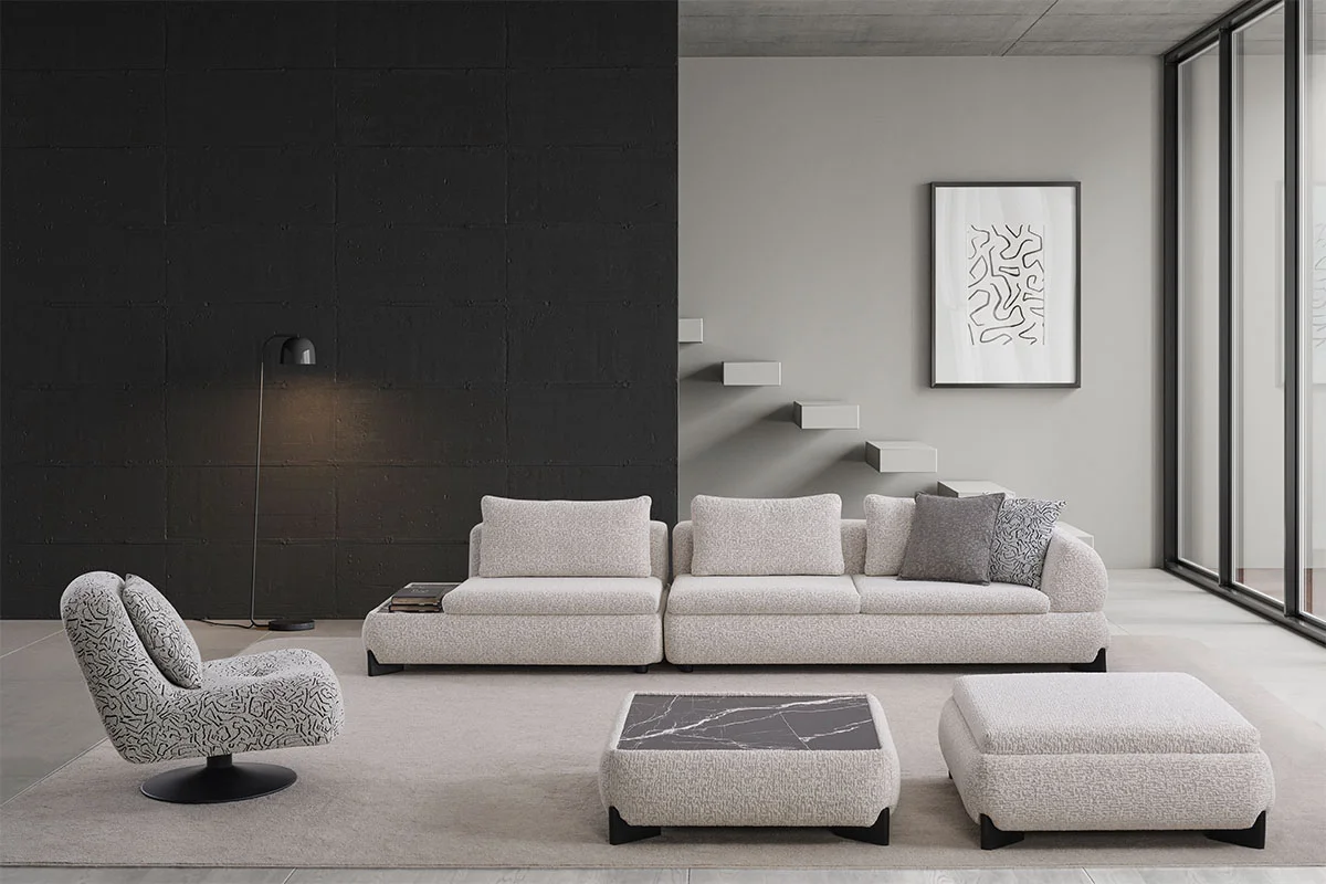 Wide view of the Aura corner sofa set with rounded modular seating, patterned swivel armchair and square center table