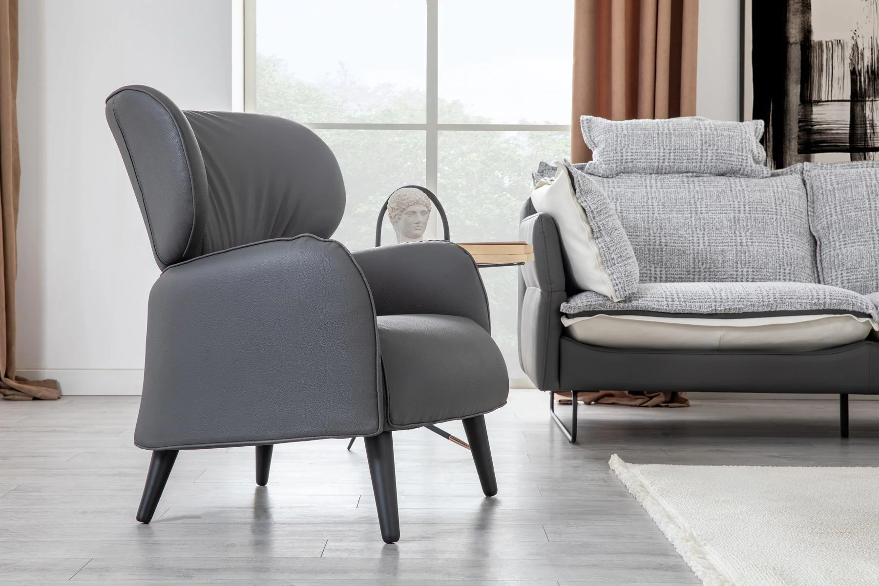 AY IŞIĞI accent armchair with slim legs beside the coordinated modern sofa