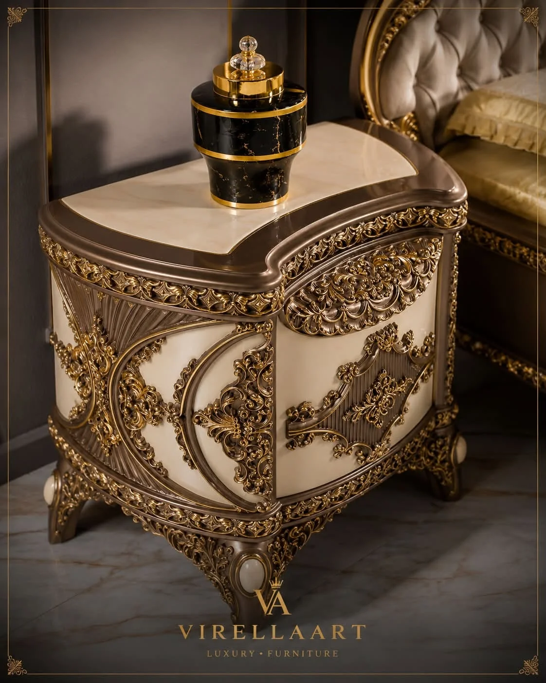 Close-up of the Milano cream nightstand with curved top, intricate gold-tone scrollwork and ornate carved legs beside the tufted bed