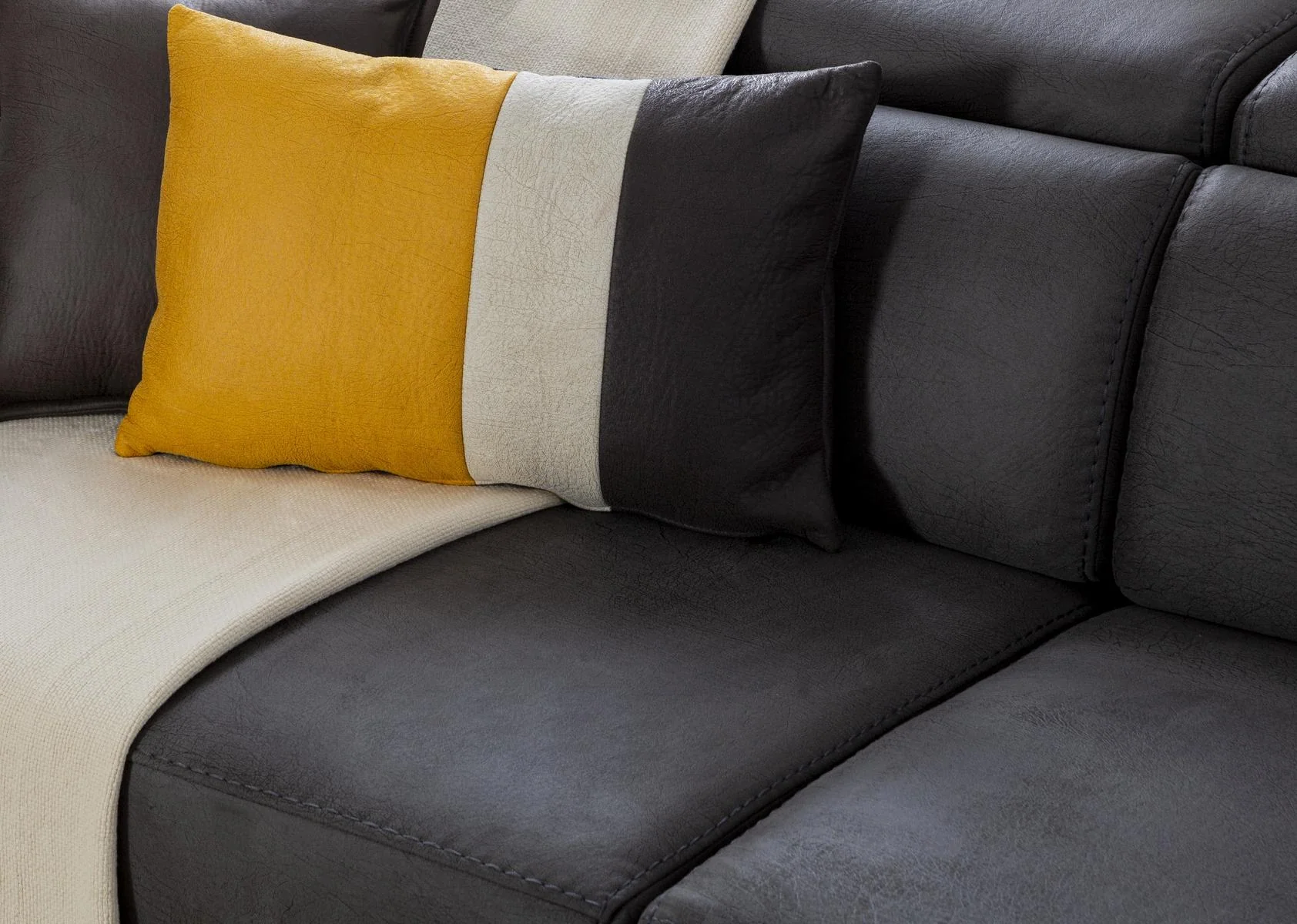 BEYRUT modern sofa cushion detail with dark upholstery and yellow accent pillow