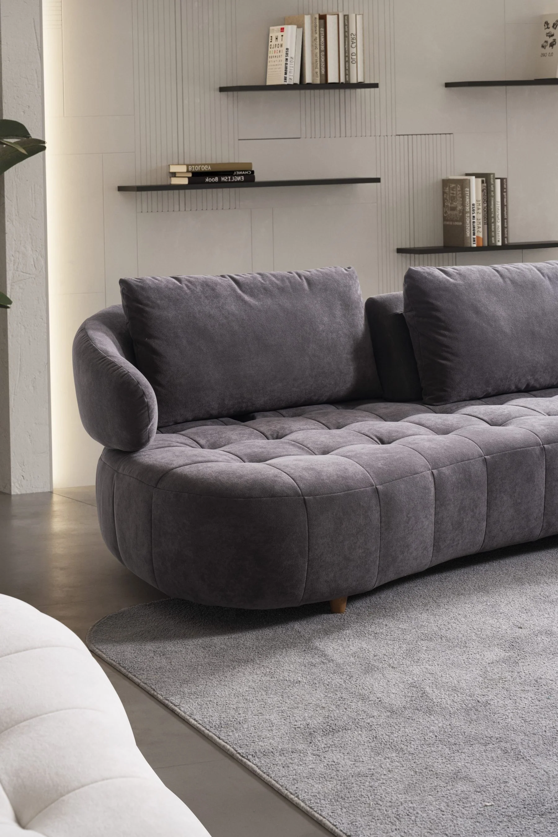BOSTON sofa close-up highlighting the curved arm, cushioned back and tailored seat structure