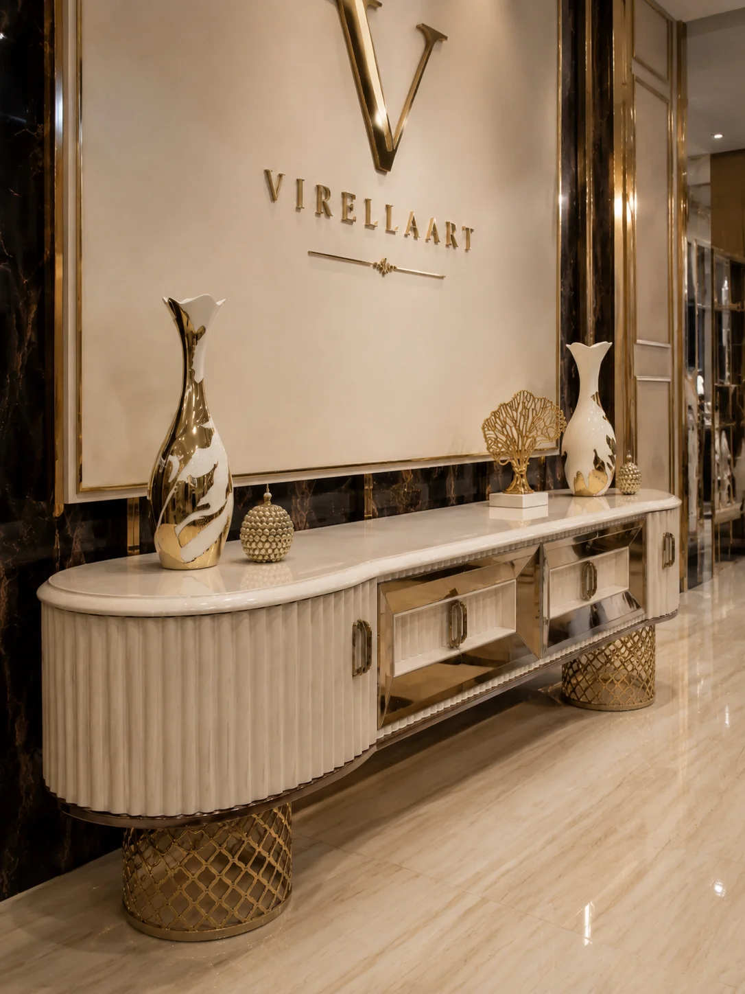Angled view of the Deluxe TV console showing its cream marble-look top, fluted curved doors, mirrored storage sections and gold-tone lattice bases