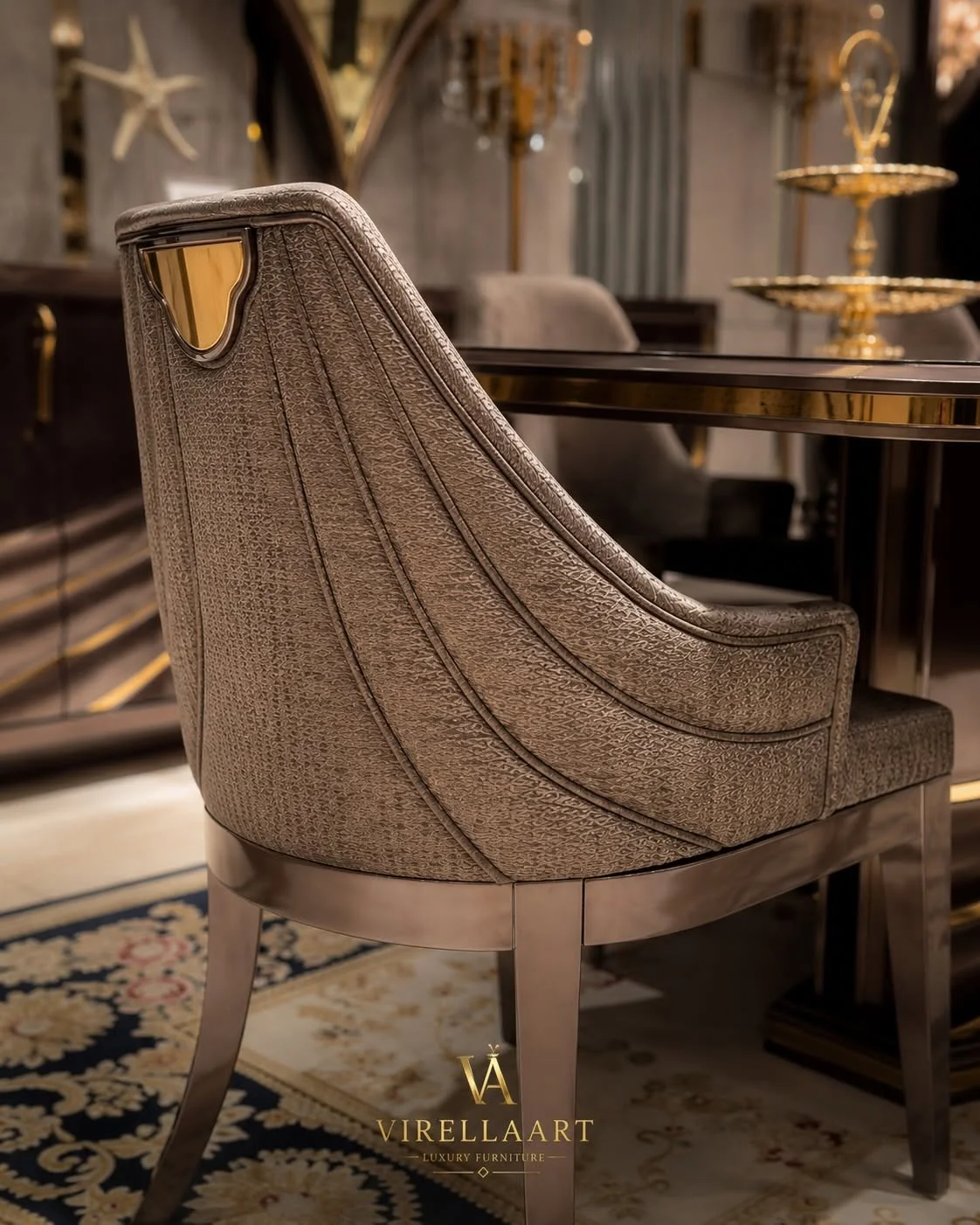 Rear view of the Shawl taupe dining chair with textured upholstery, sweeping stitched lines, gold-tone crest and metallic tapered legs
