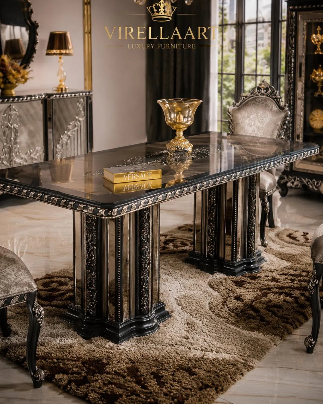 Close-up of the Zumrut rectangular dining table with a glossy dark top, carved silver-tone trim, twin pedestal bases and tufted chairs