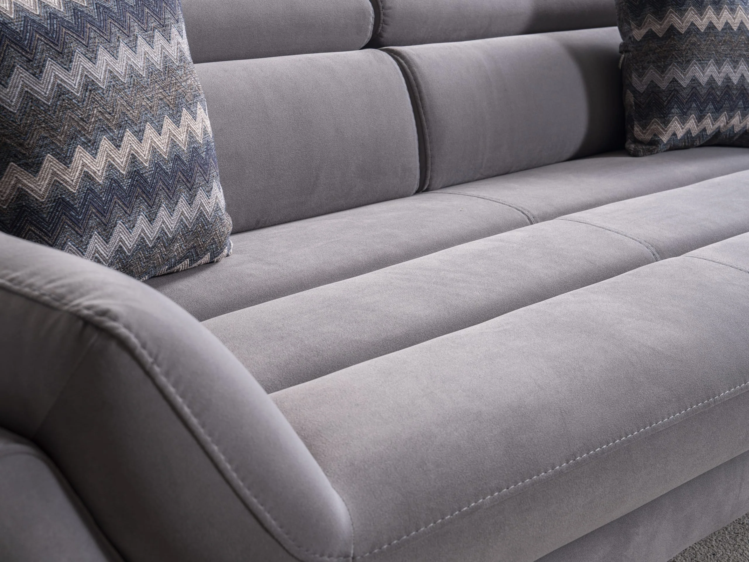 EFTELYA sofa close-up showing the channeled back detail and layered arm design