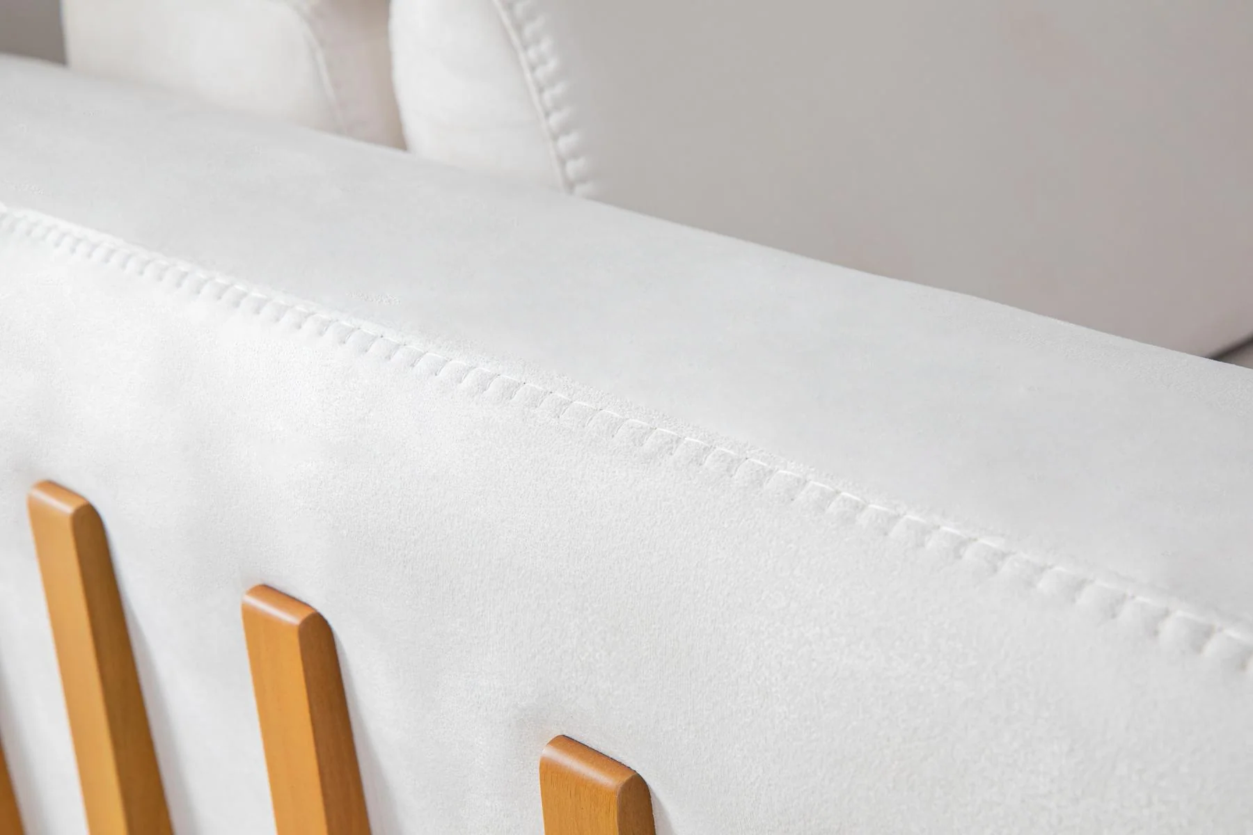 HÜNKAR white three-seat sofa and sculptural accent chair in a contemporary interior