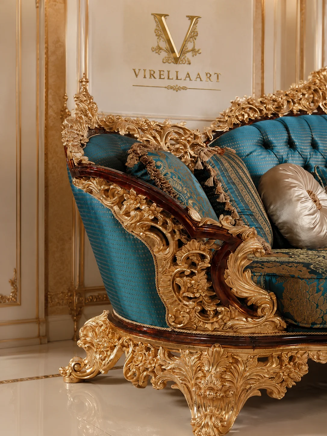 Close-up of the Sultan sofa arm and base with turquoise upholstery, dark wood edging and dense gold-tone floral carving