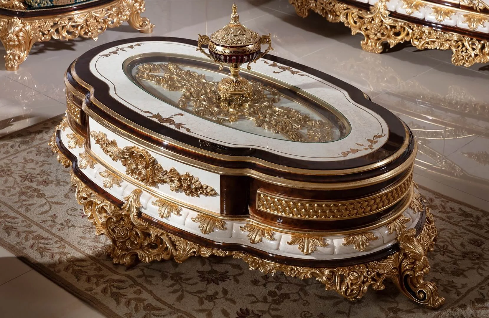 Sultan oval center table with an ivory and dark brown finish, glass inset and elaborate gold-tone carved ornament