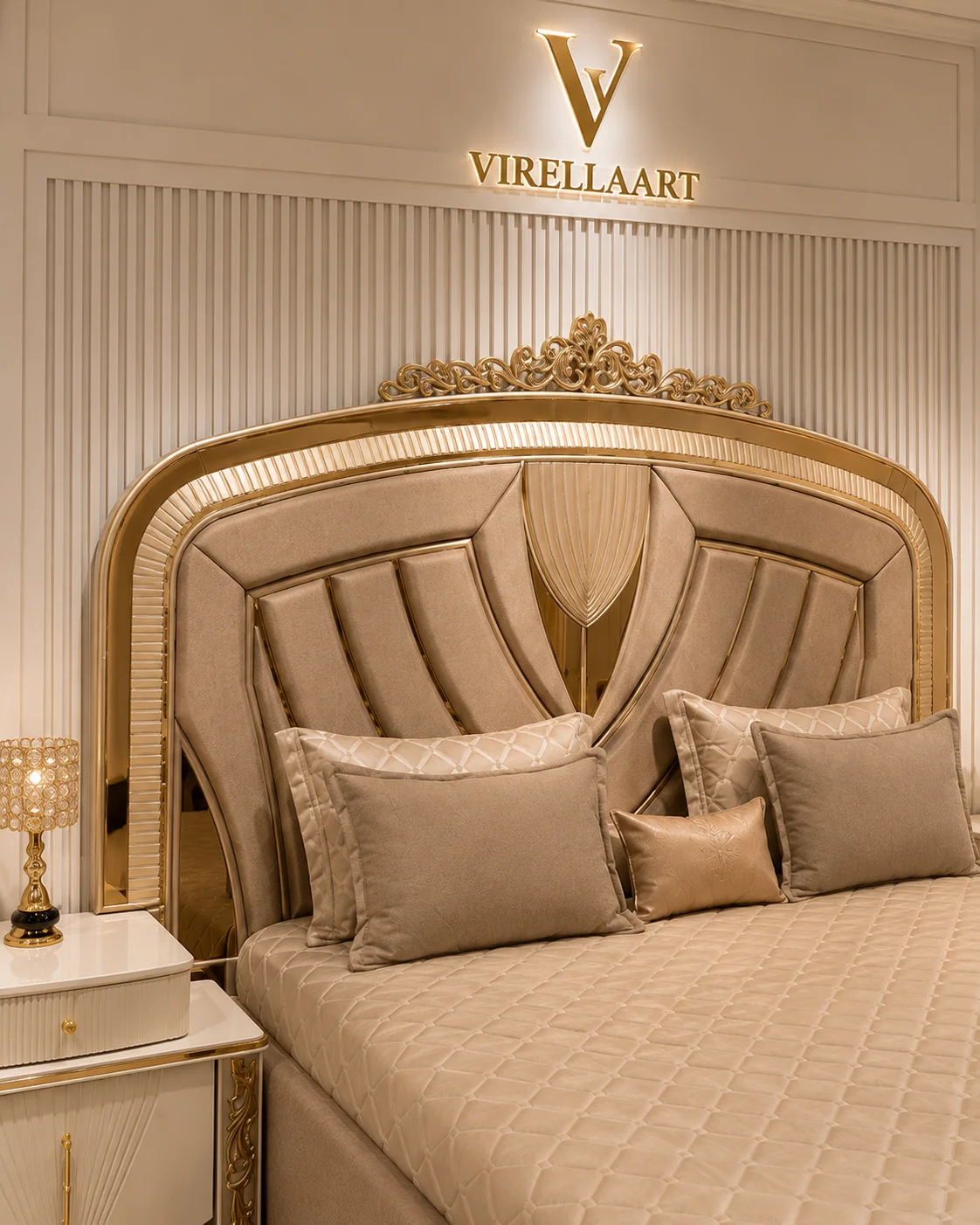 Close-up of the Valencia padded headboard with sweeping channel panels, central fan-shaped detail and ornate gold-tone crest