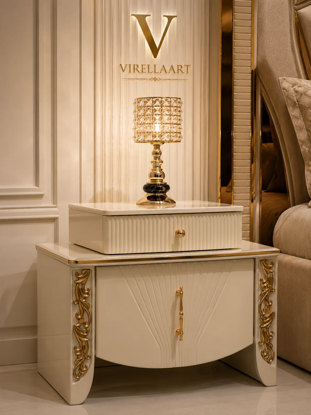 Close-up of the Valencia cream nightstand with fluted drawer, curved cabinet front, gold-tone carved sides and crystal table lamp