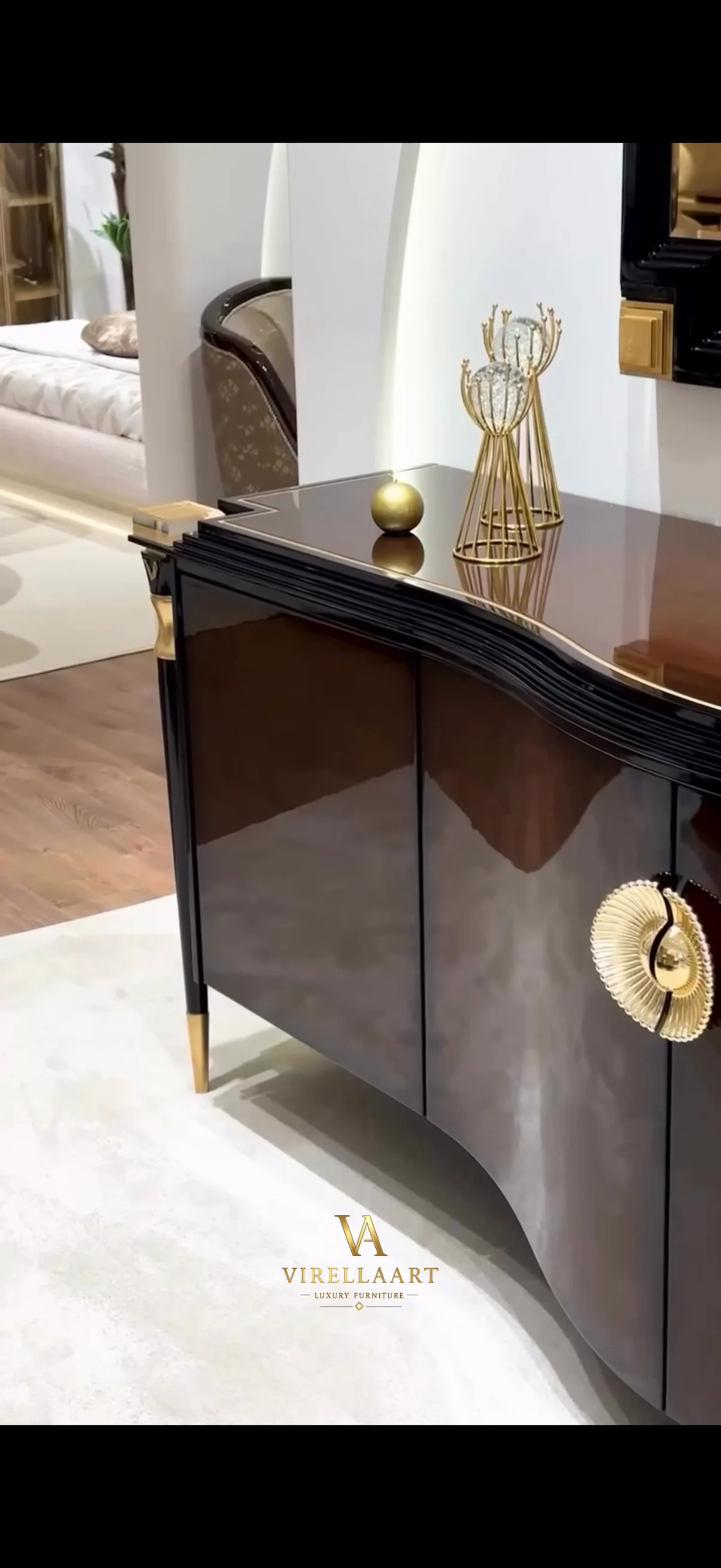Close-up of the Vanessa curved dining sideboard with glossy dark brown doors, gold-tone medallion and polished top